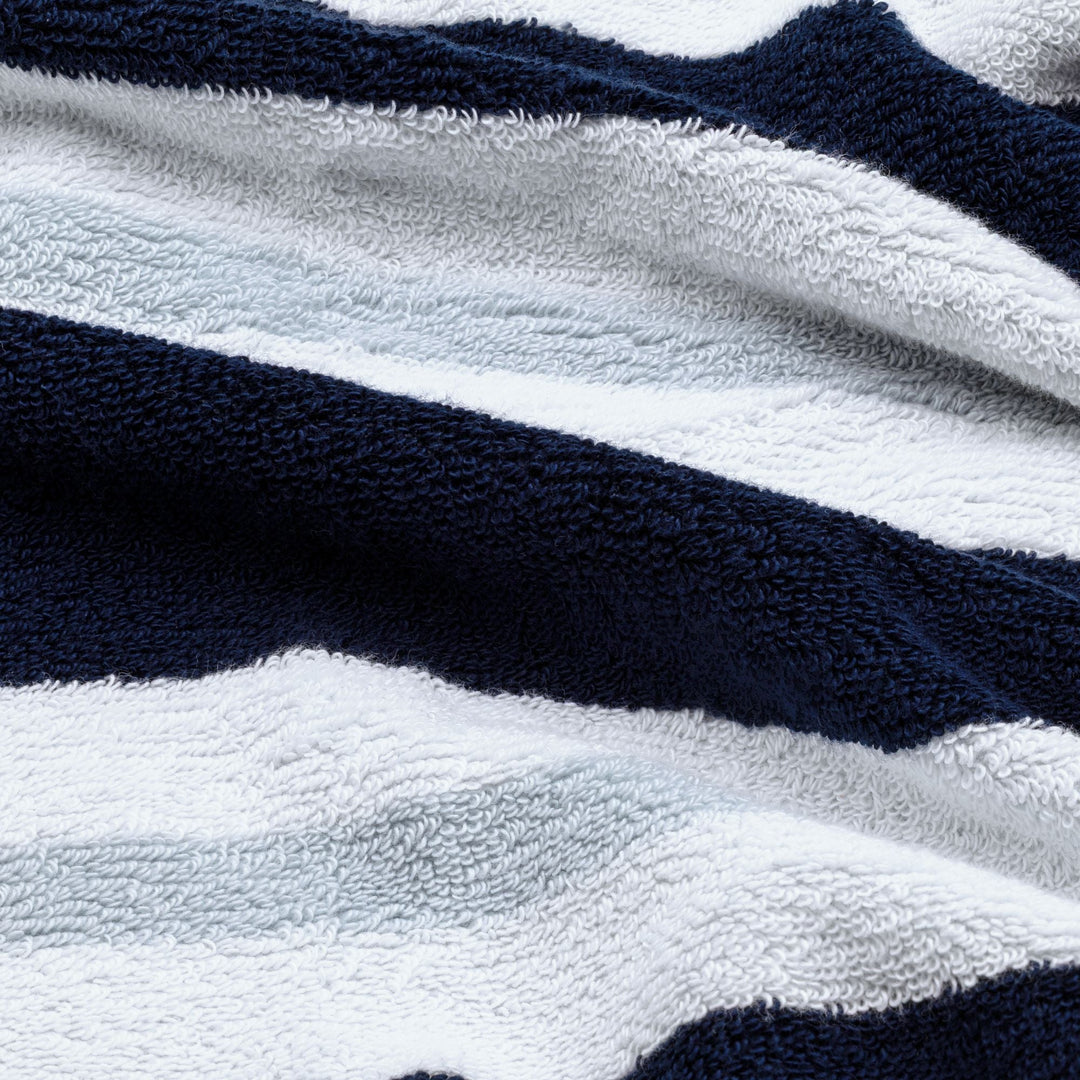 Navy and white striped cotton beach towel with soft terry texture