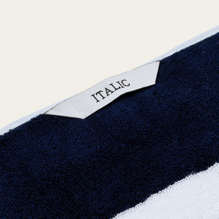 "ITALIC" woven label on dark navy cotton towel edge