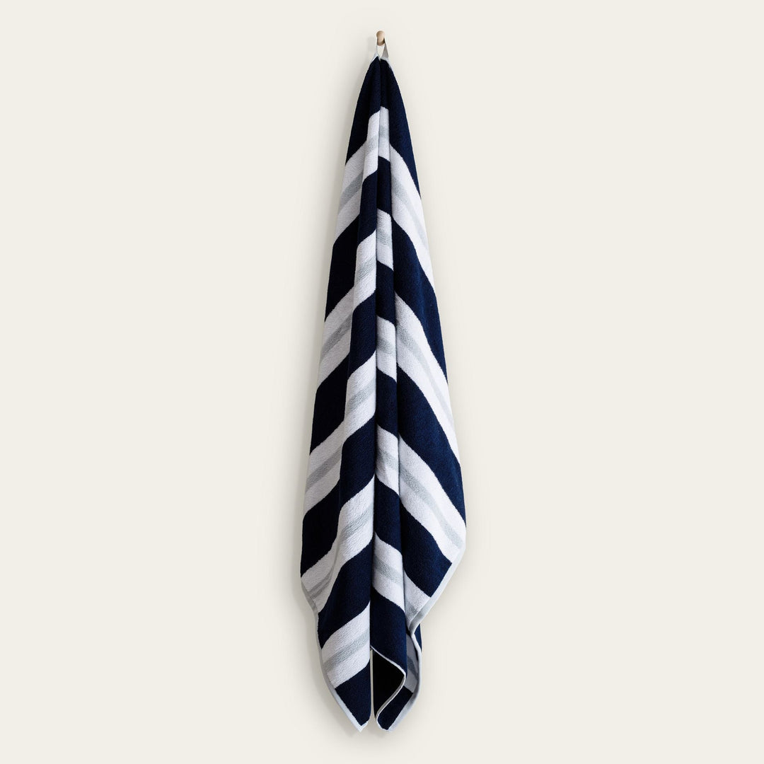 Hanging cotton beach towel with navy and white diagonal stripe pattern