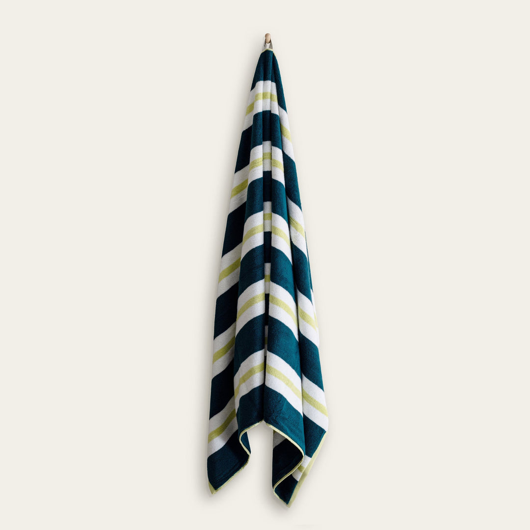 Hanging cotton beach towel, navy and white with light green striped sections.