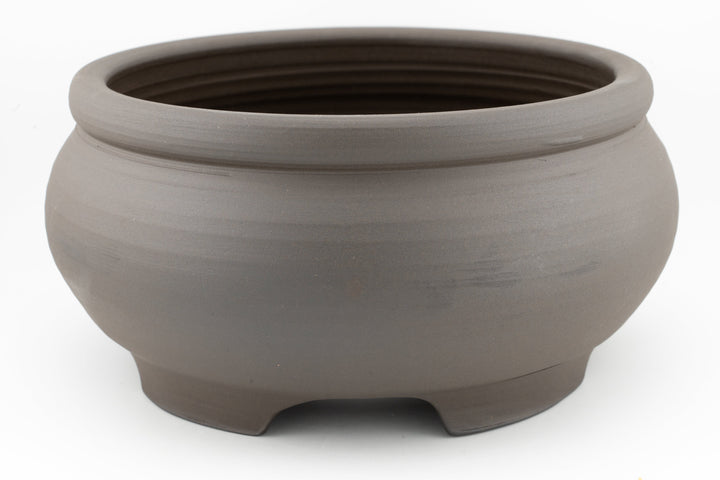Unglazed dark brown stoneware bonsai pot with three-foot base and round rim
