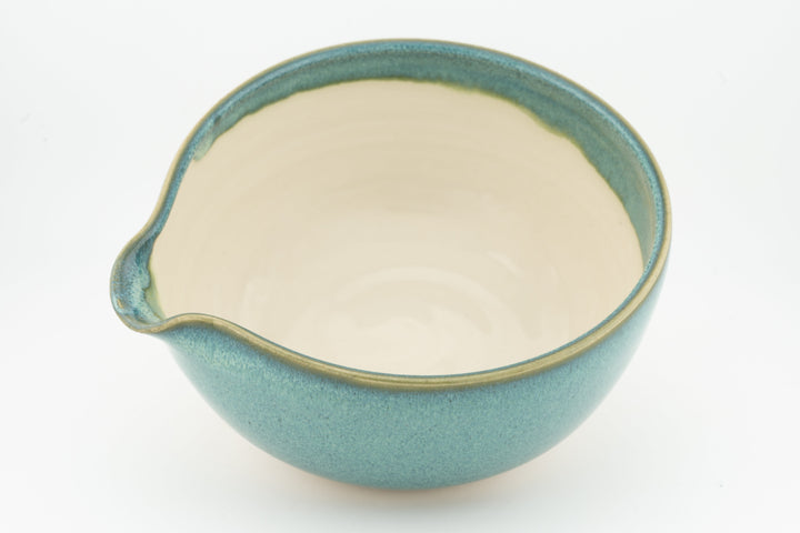 Ceramic bowl with optional spout, teal exterior and cream interior, front spout view
