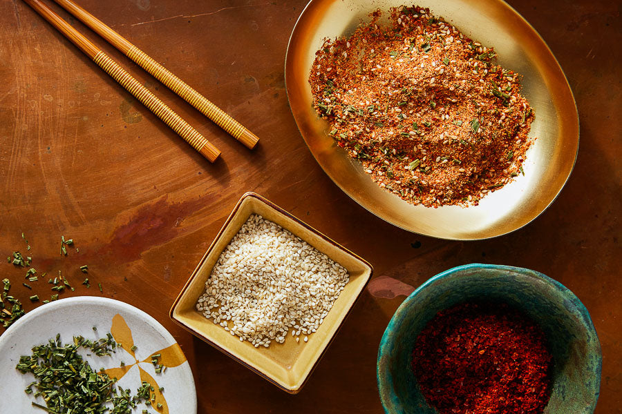 Bulgogi spice mix in small bowl with chopsticks and nearby seasoning dishes