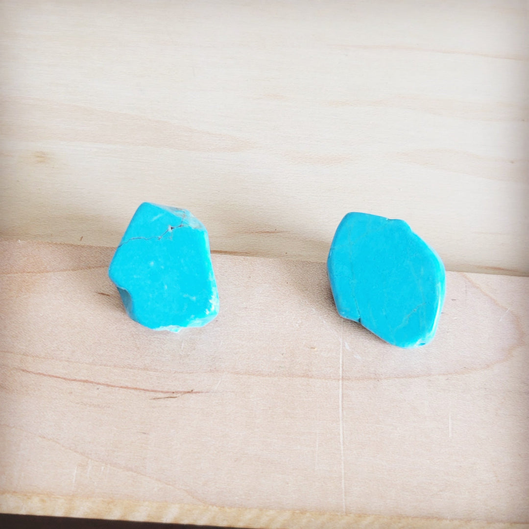 Turquoise slab earring studs with irregular blue fronts, lying flat
