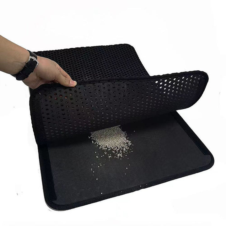 Double-layer EVA cat litter mat with black honeycomb top, folded for storage