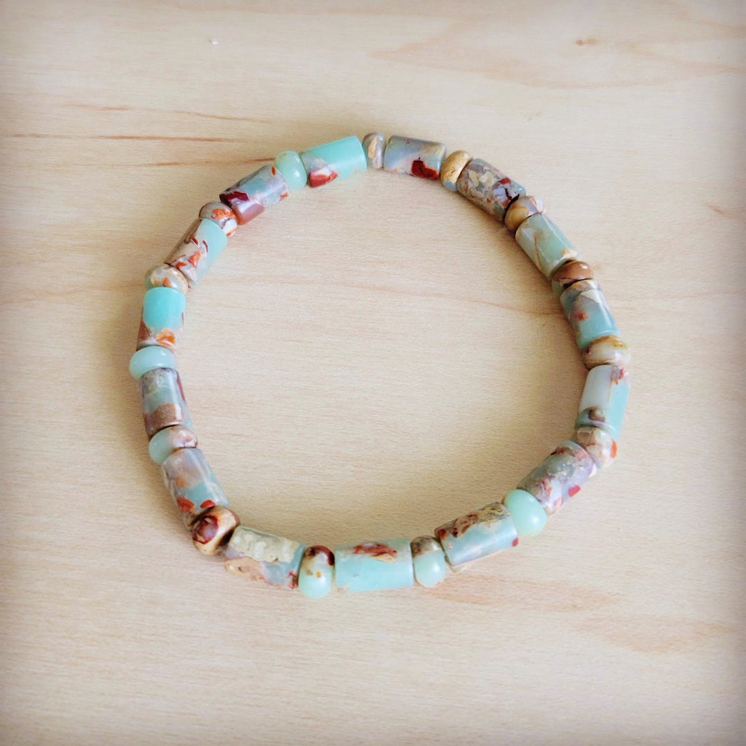Beaded stretch bracelet with turquoise and tan barrel beads and multicolor accents