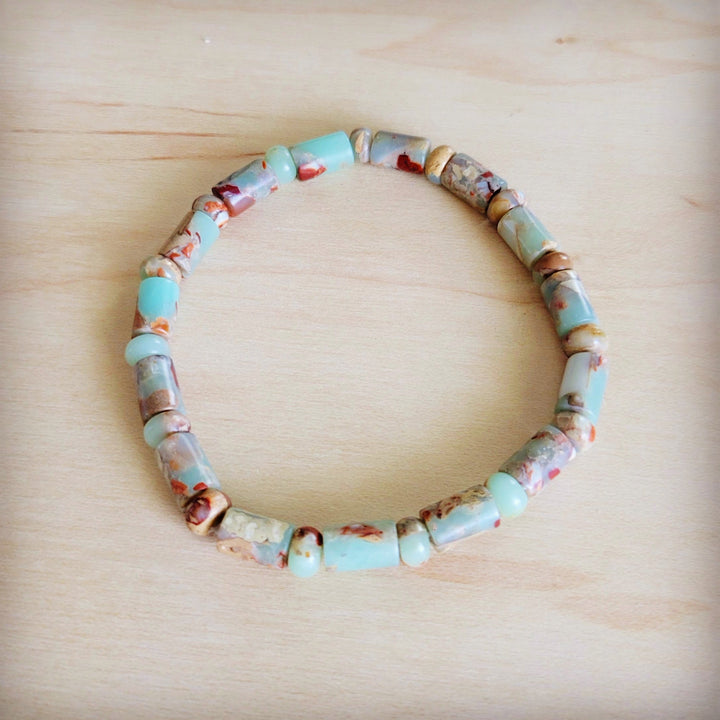Beaded stretch bracelet with turquoise and tan barrel beads and multicolor accents