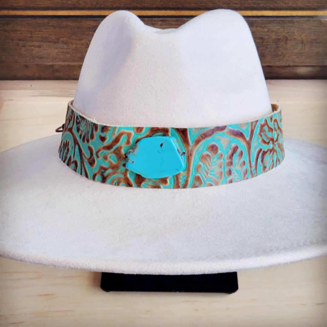 White felt cowboy hat with wide turquoise patterned leather hat band and turquoise center buckle