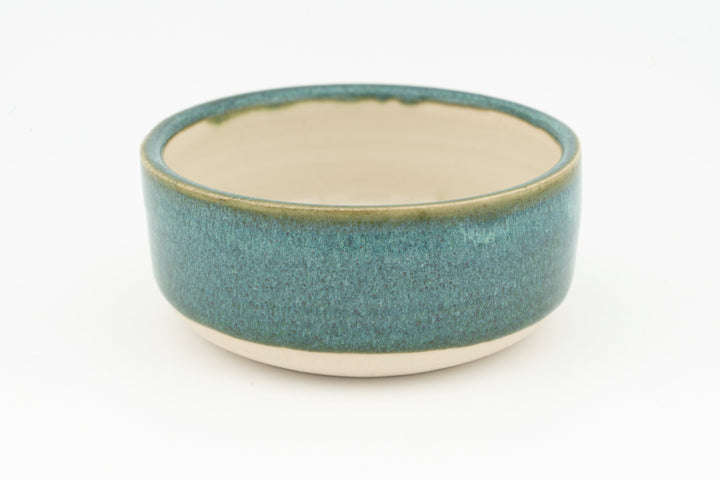 Ceramic condiment cup with solid teal exterior and cream interior