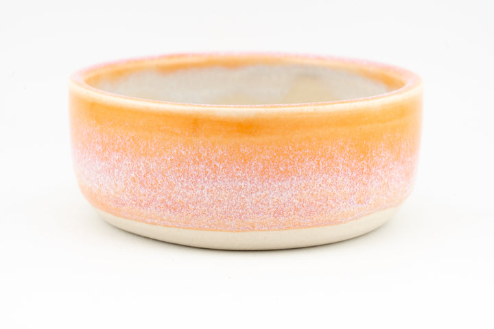Ceramic condiment cup with coral-orange speckled exterior and cream interior