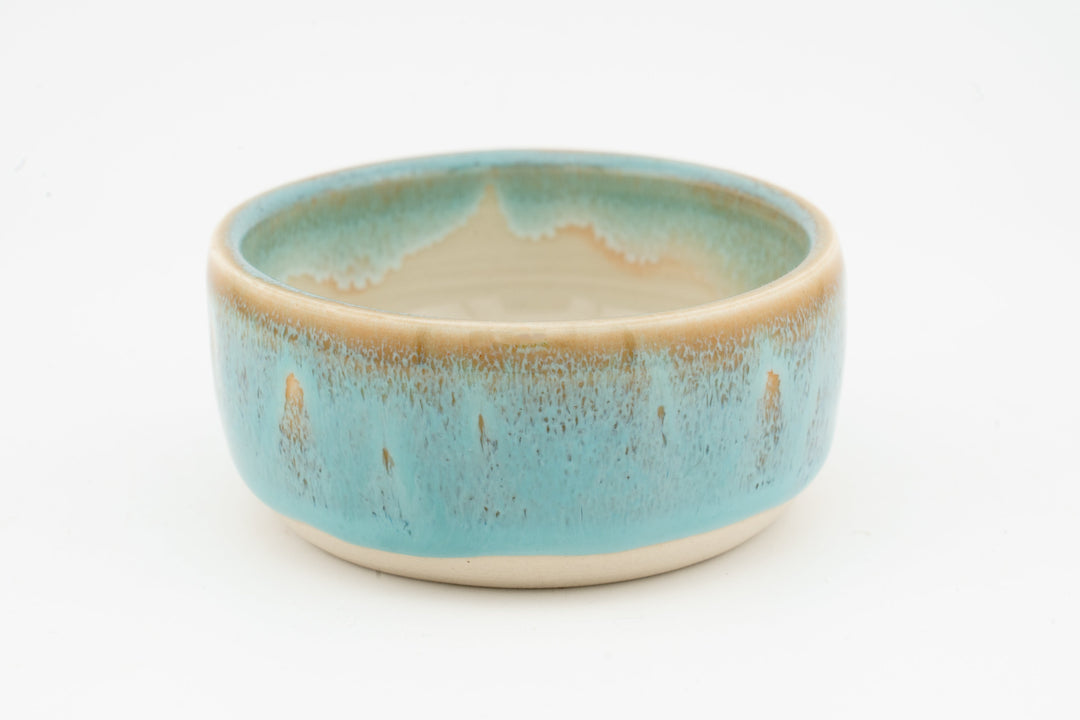 Ceramic condiment cup with speckled turquoise-blue glaze and cream inner rim