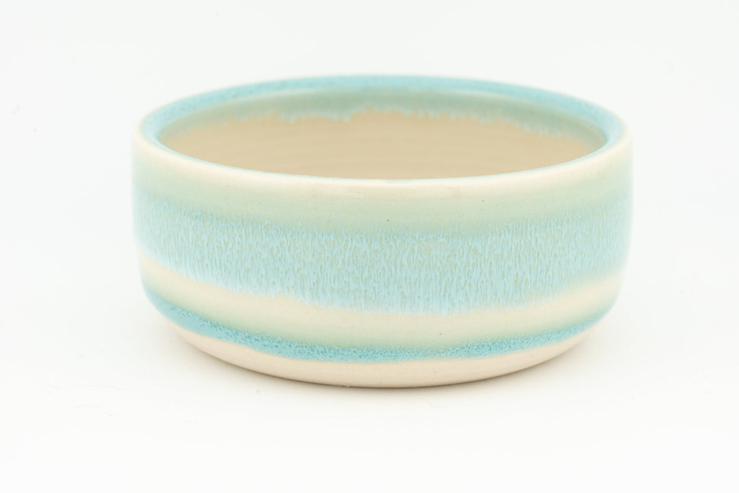 Ceramic condiment cup with pale turquoise glaze, cream interior, and smooth rim