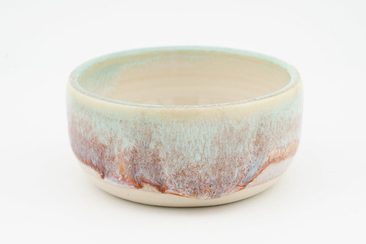 Ceramic condiment cup with cream base and multicolor speckled glaze, teal and orange tones