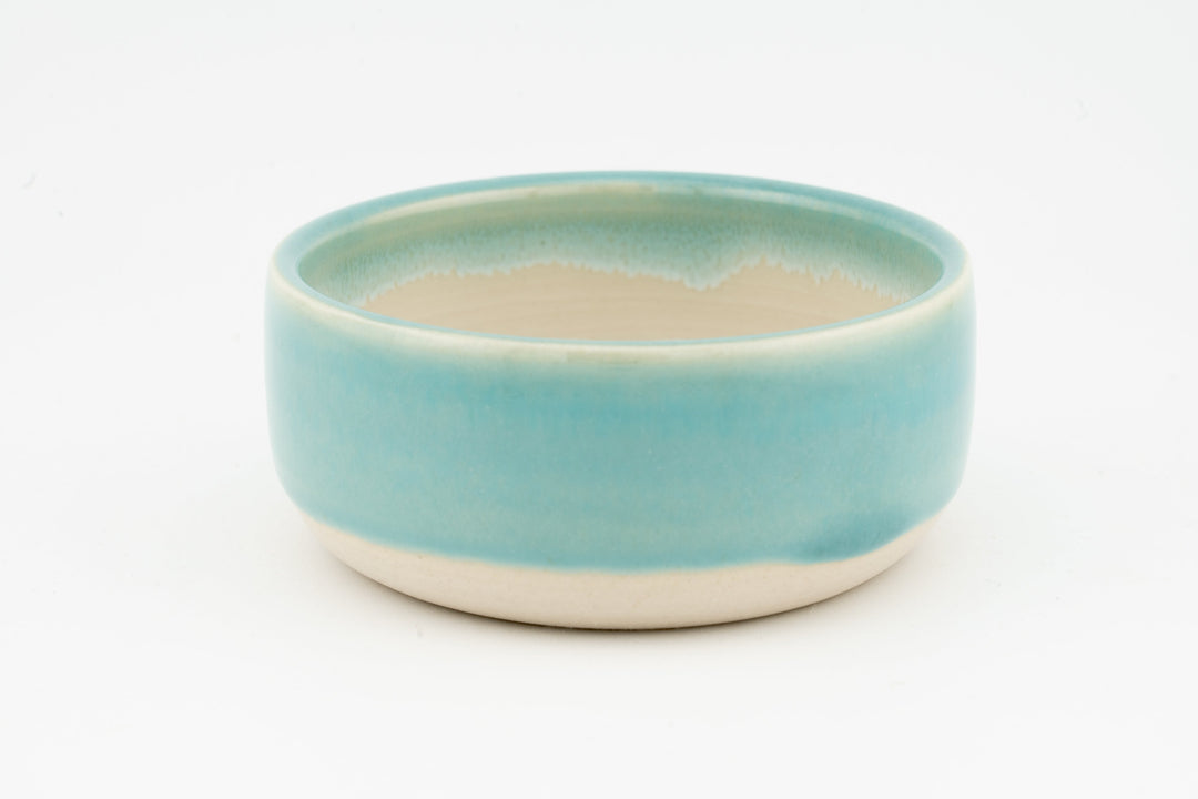 Ceramic condiment cup with smooth light aqua glaze and cream base