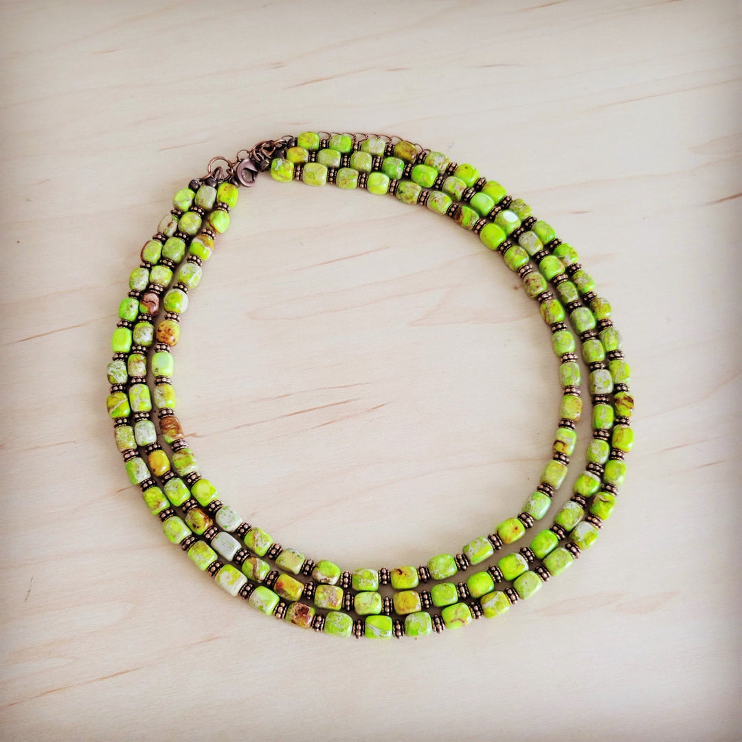 Layered beaded necklace with lime green and dark brown square beads, copper clasp