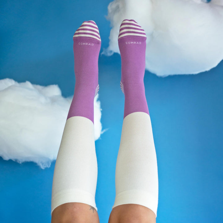 Pair of colorblock compression socks: mulberry tops, cream shafts, striped toes