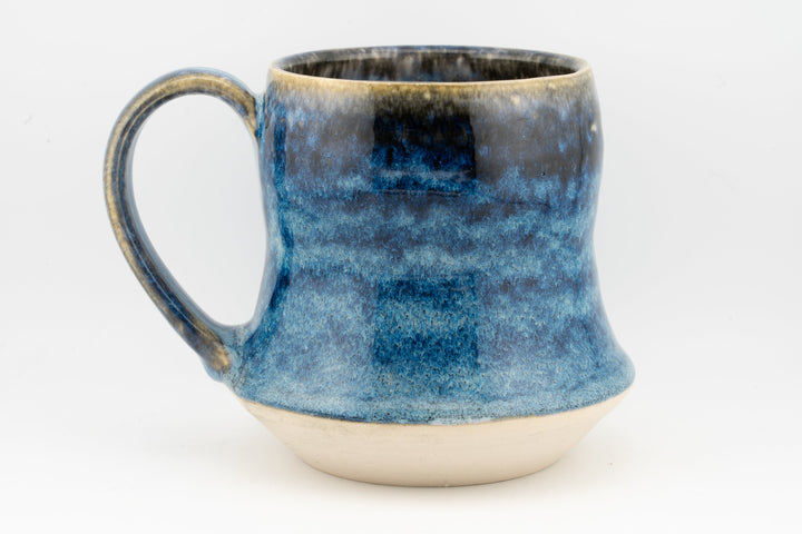 Blue speckled tall ceramic mug with side handle and wide rounded rim