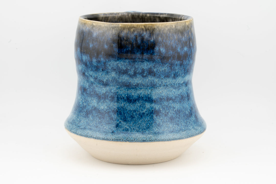 Blue speckled tall ceramic mug, front view with handle cutout visible on side
