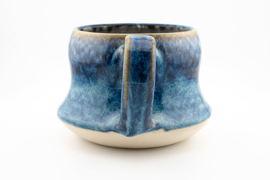 Curvy wide mug, blue speckled ceramic glaze with back-facing loop handle
