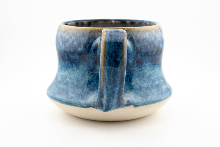Curvy wide mug, blue speckled ceramic glaze with back-facing loop handle