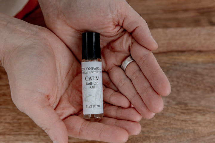 Calm roll-on oil bottle with black cap and small glass vial, 10 ml