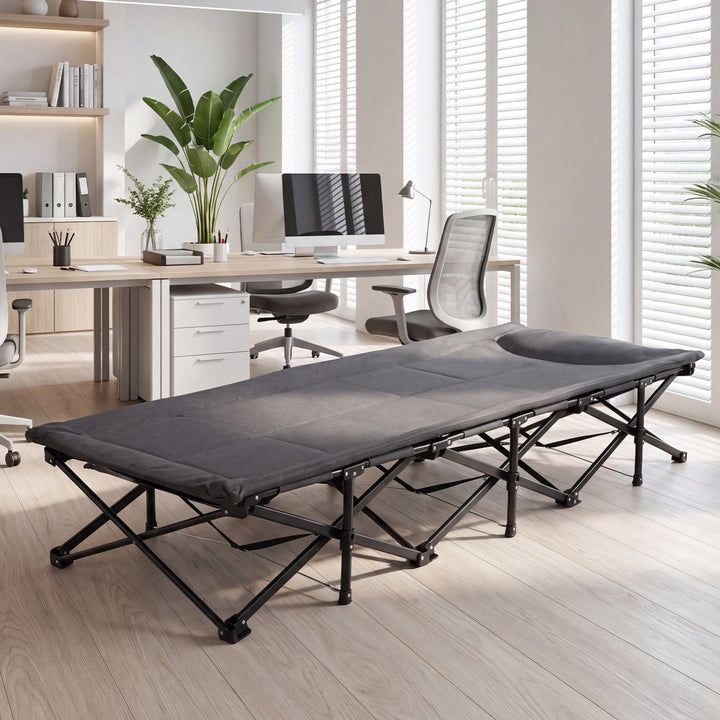 Gray folding camping cot with padded headrest and black metal frame