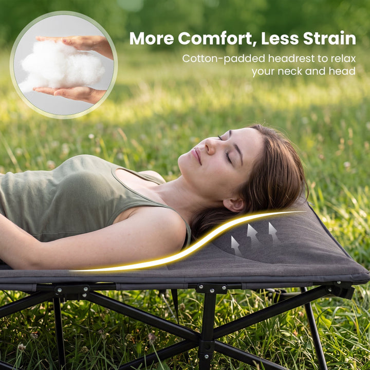 Padded gray headrest on a folding camping cot with black metal frame