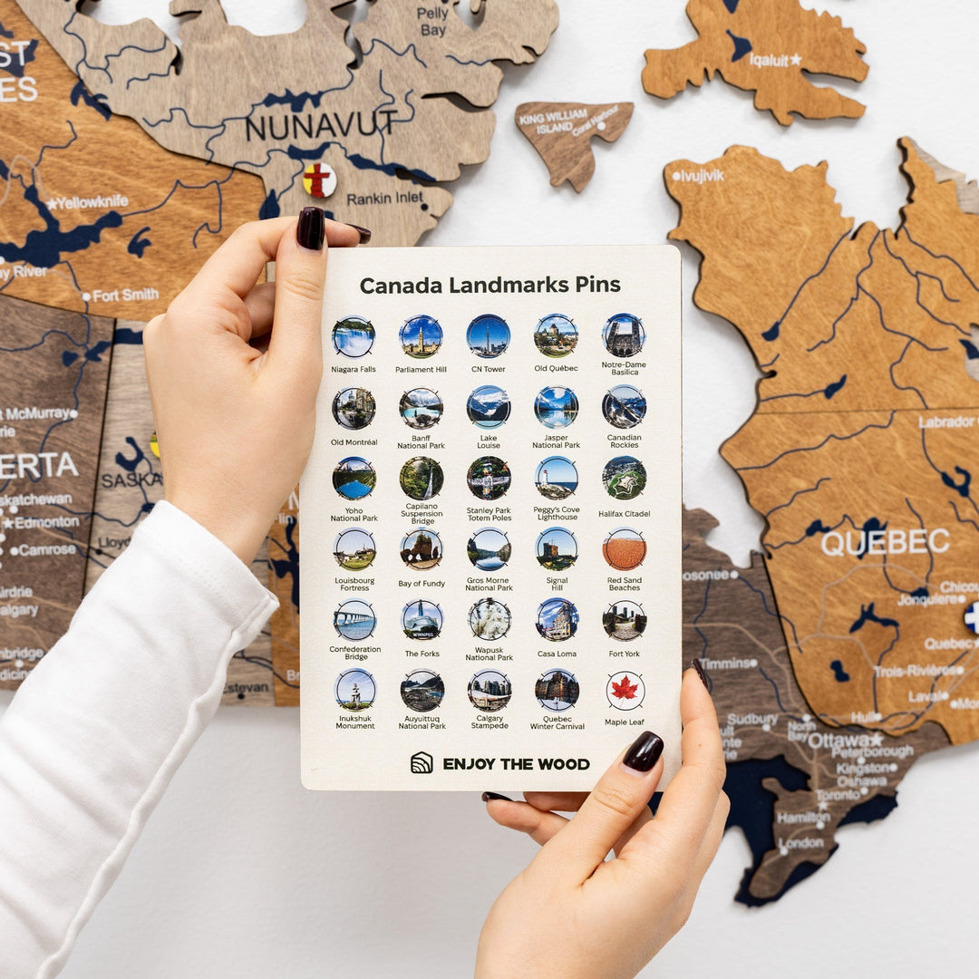 Canada landmarks pin set card with blue-and-gold round pins, held above Canada map