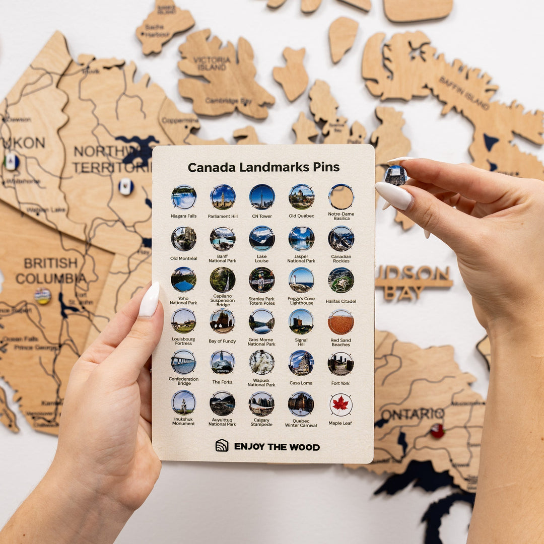 Canada landmarks pin set card with assorted circular pins, close view held in hands