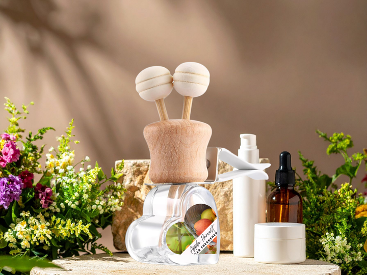 Car air vent diffuser with wooden clip, clear refill pod, and amber oil bottle