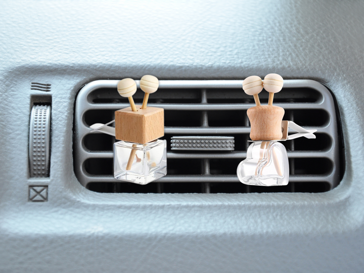 Car vent diffuser set: two wooden holders with glass bottles clipped to air vent