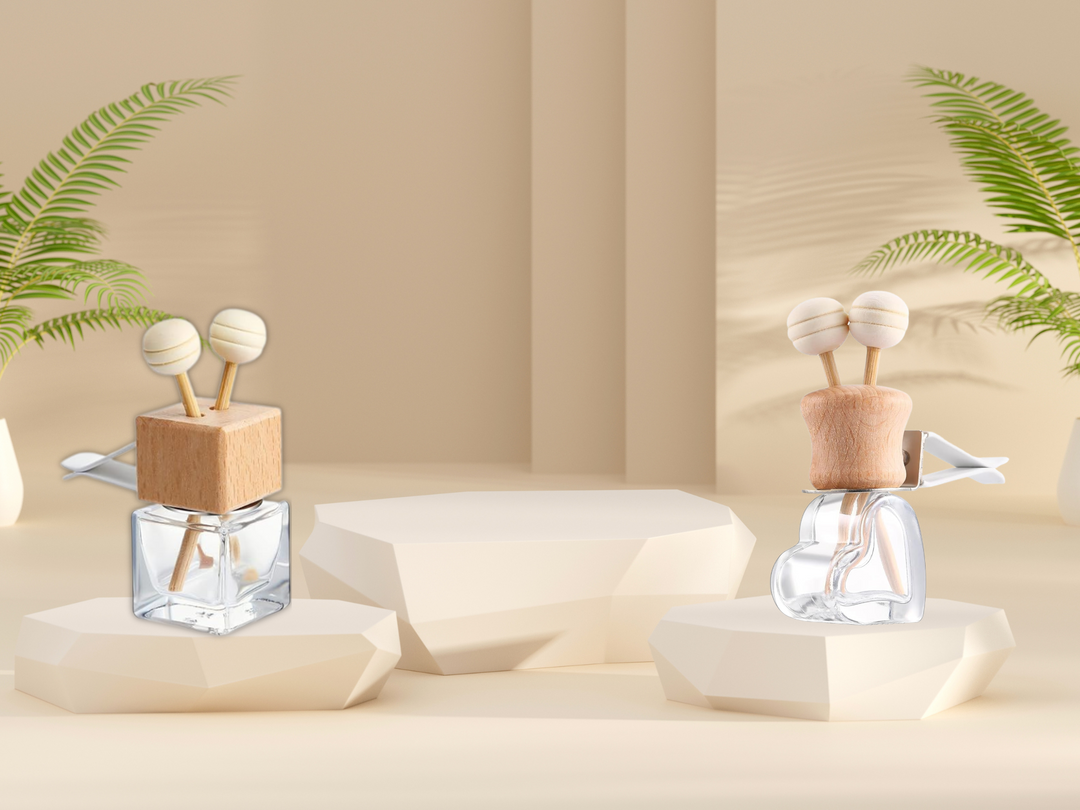 Car vent diffuser collection with two glass bottles and wooden holders on dashboard
