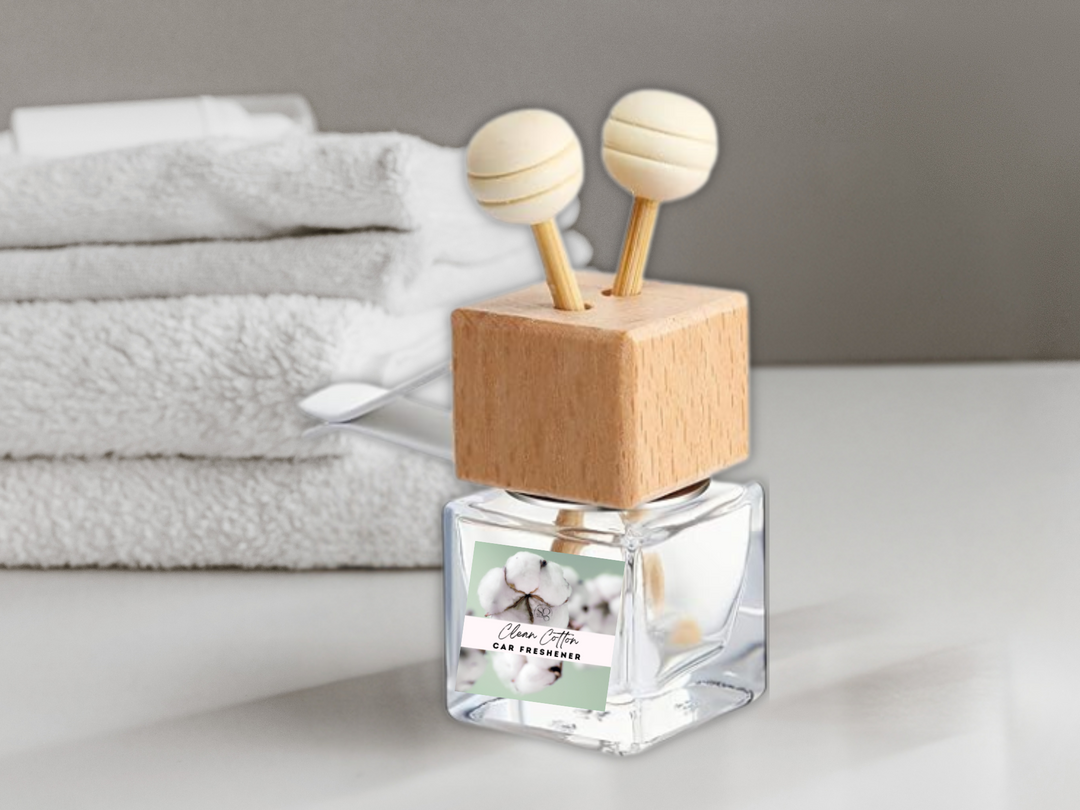 Square clear car diffuser bottle with wooden cube base and two white diffuser caps