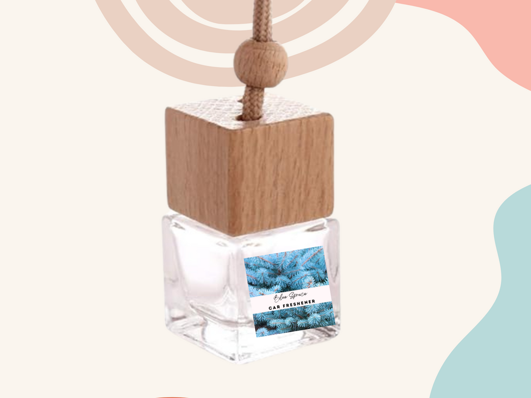 Hanging car freshener bottle with wooden cube cap and clear vial on light background.
