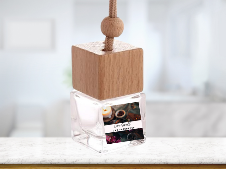 Hanging car freshener on a cord: clear glass bottle with wooden cube top