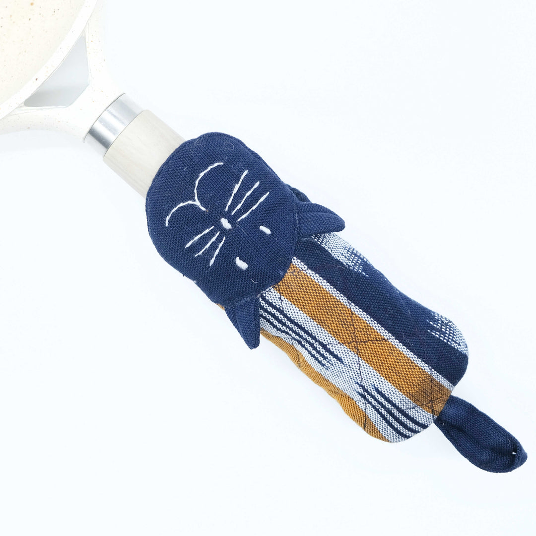 Cat skillet handle holder, dark blue striped sleeve with white cat whisker face.