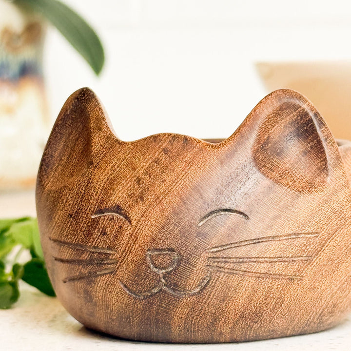 Carved cat-shaped wooden bowl with raised cat ears and face, empty interior