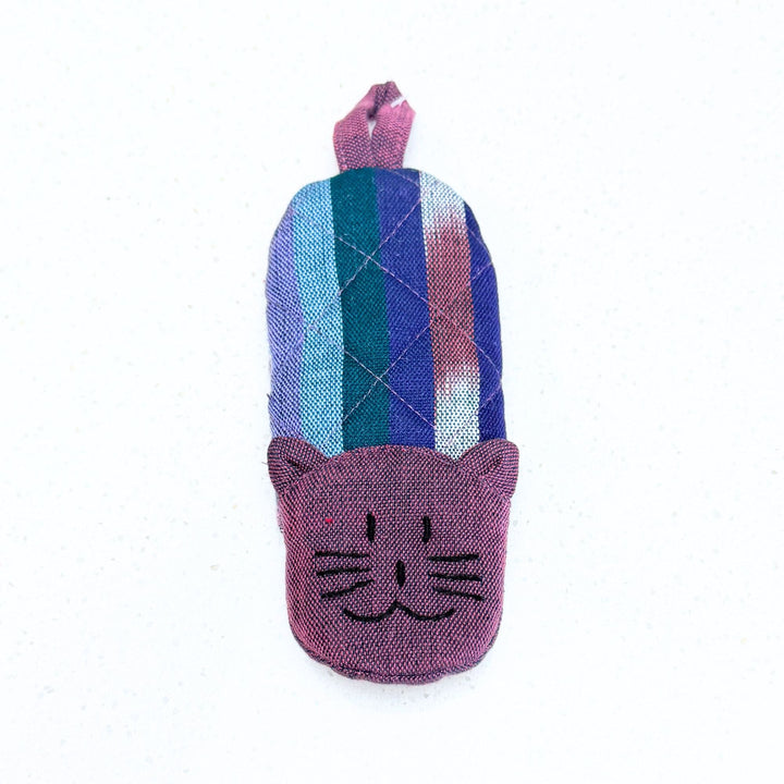Cat skillet handle holder with purple, blue, and teal patchwork stripes and cat face