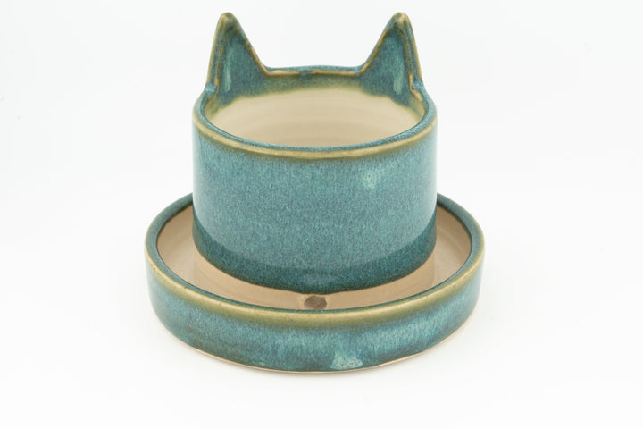 Teal cat planter cup with rounded saucer base, curved cat-ear silhouette