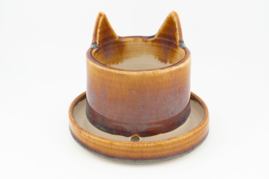 Amber-orange cat planter with matching saucer, cat ears and face indentations