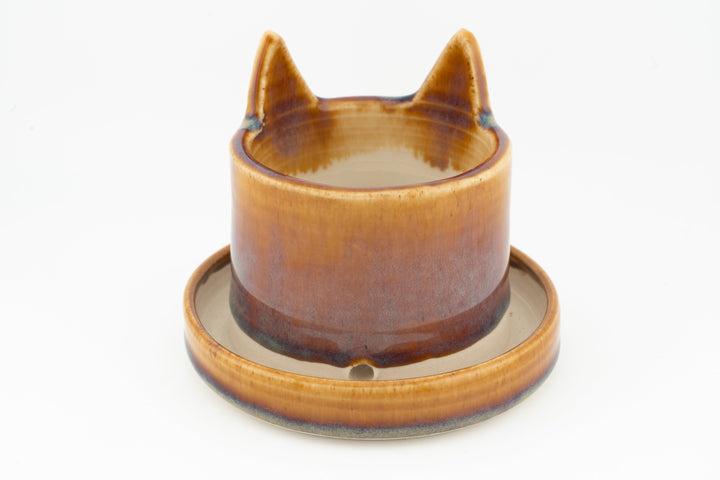 Amber-orange cat planter with matching saucer, cat ears and face indentations