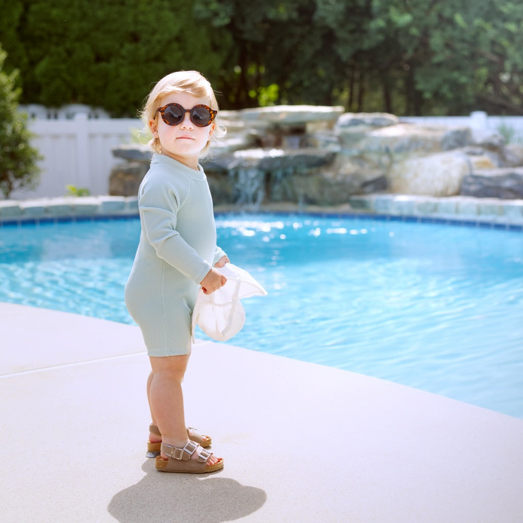 Mint ribbed long-sleeve baby swimsuit romper with snap front and short legs