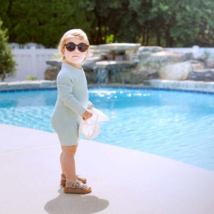 Mint ribbed long-sleeve baby swimsuit romper with snap front and short legs