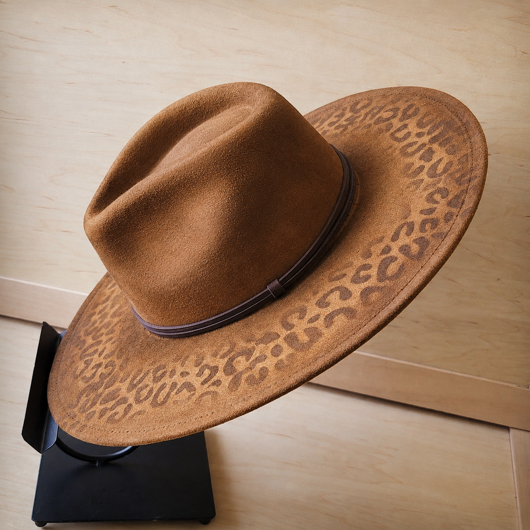 Tan felt wide-brim cowgirl hat with leopard-print underside and dark hatband