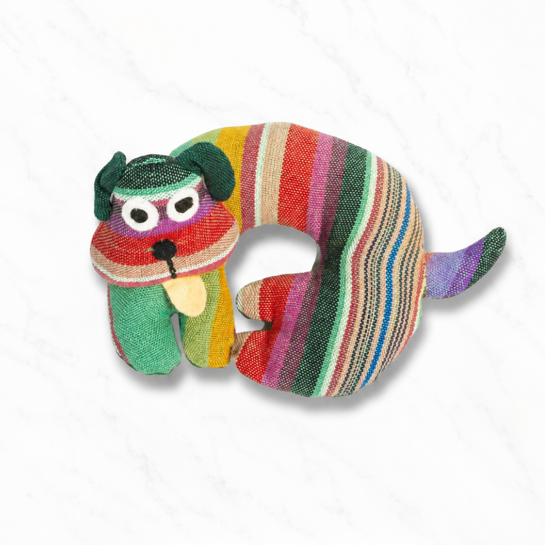 Fabric dog-shaped trivet with green, red, and striped fabric and a smiling dog face
