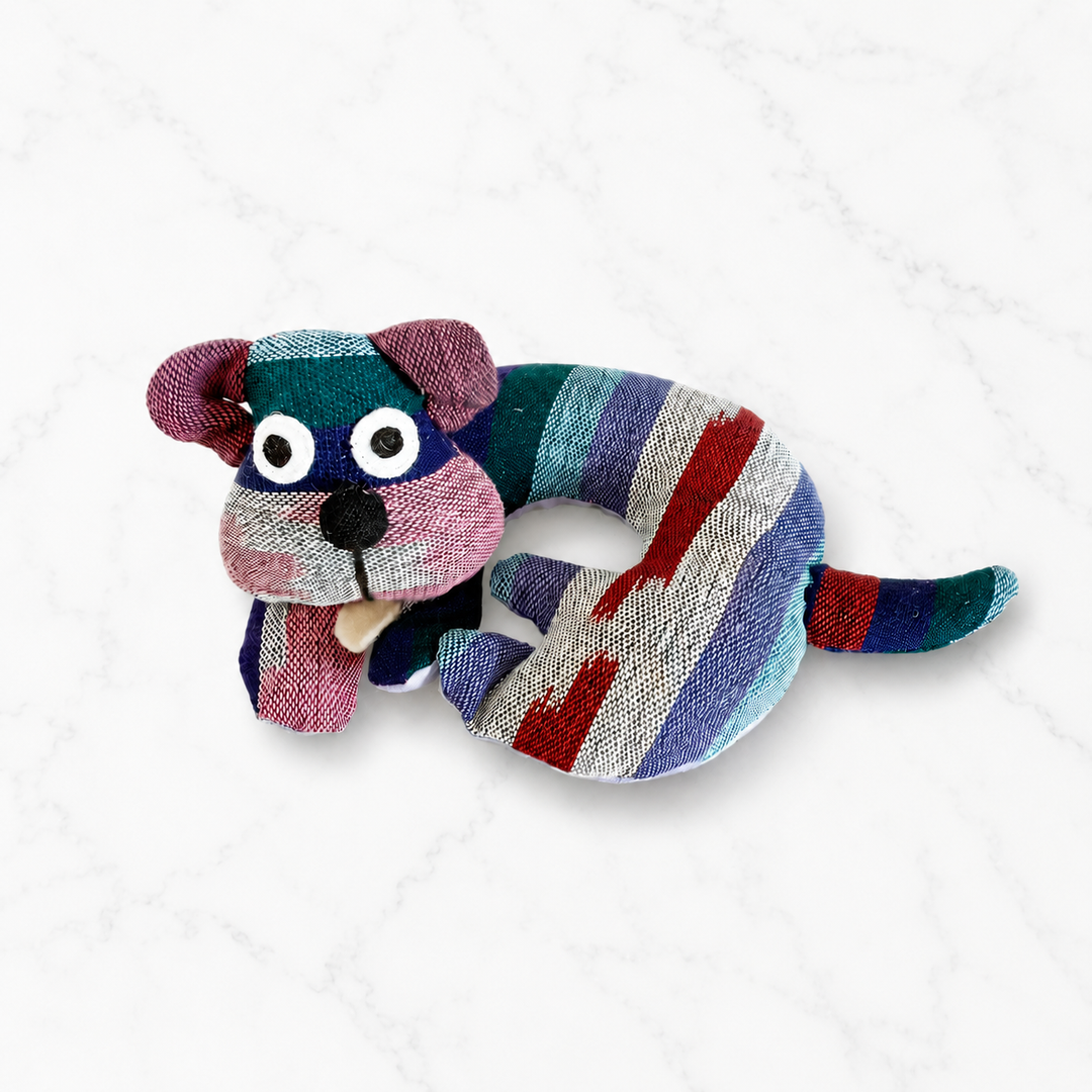 Fabric dog-shaped trivet with multicolor stripes and a purple dog face and ears