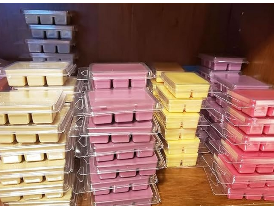 Stacked clamshell wax melt trays with assorted pastel square cube colors