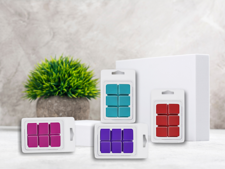 Retail clamshell assortments of purple, teal, and red wax melt cubes