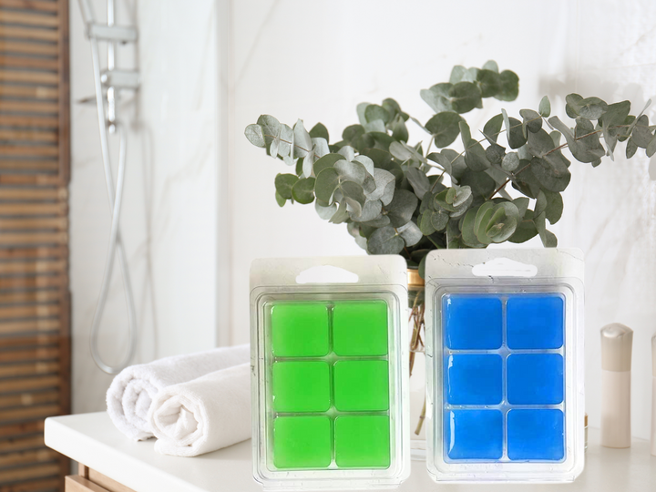 Green and blue wax melt cube trays in clear clamshell containers
