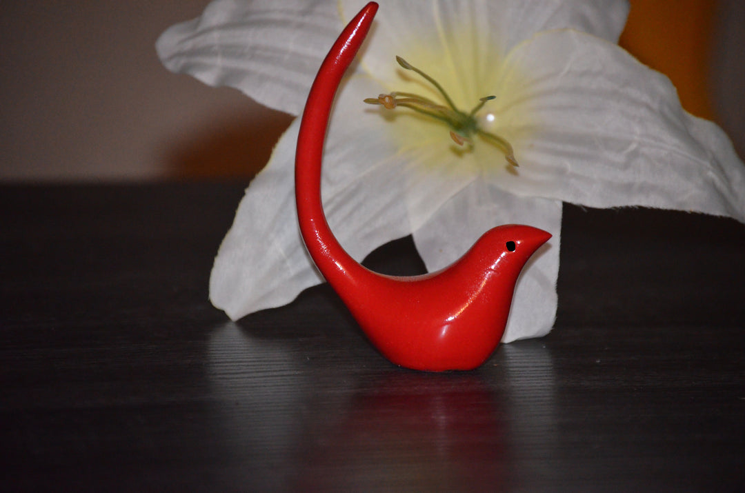 Red bird-shaped ring holder with curved tail and beak